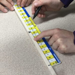 Child measuring carefully